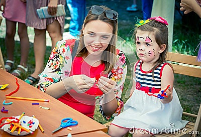 Mother and daughter participating at art and craft outdoor workshop Editorial Stock Photo